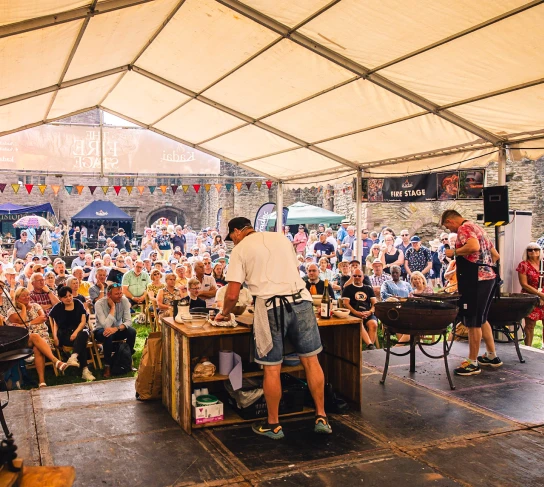 Visitors enjoy a presentation on Kadai Fire stage